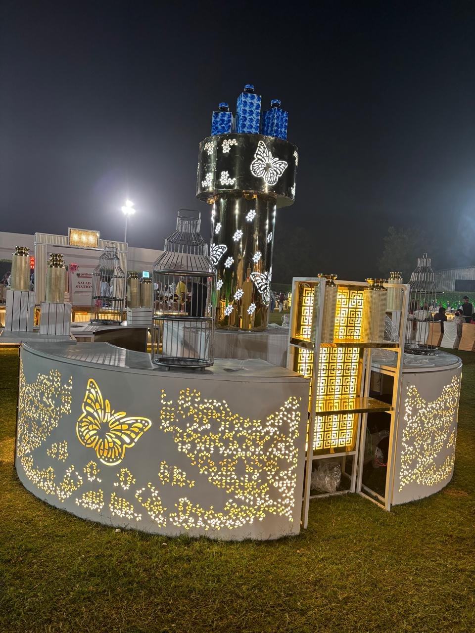 Beautifully decorated food table with floral arrangements and lighting