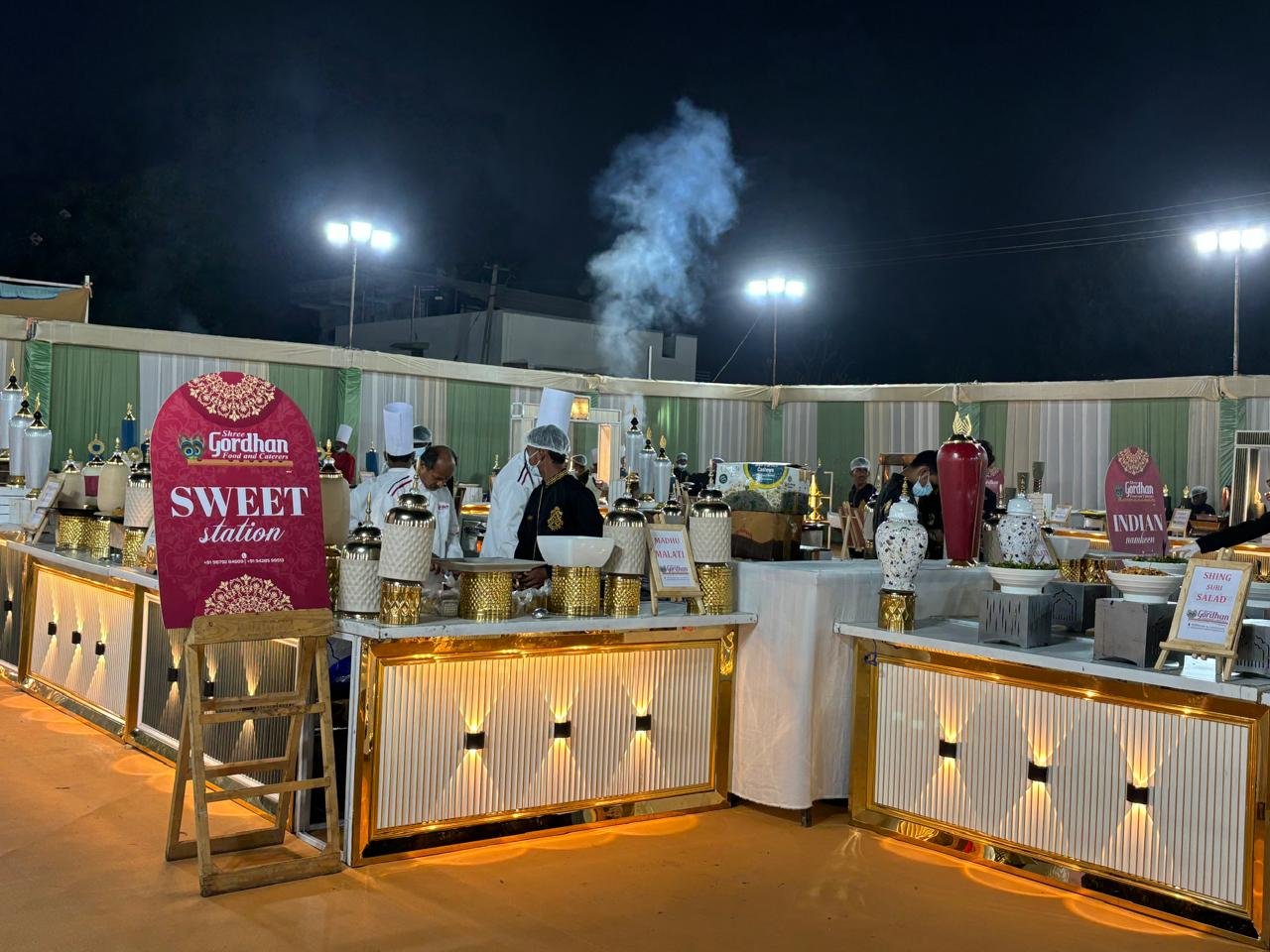 Assorted Indian sweets including gulab jamun, rasgulla, and kaju katli